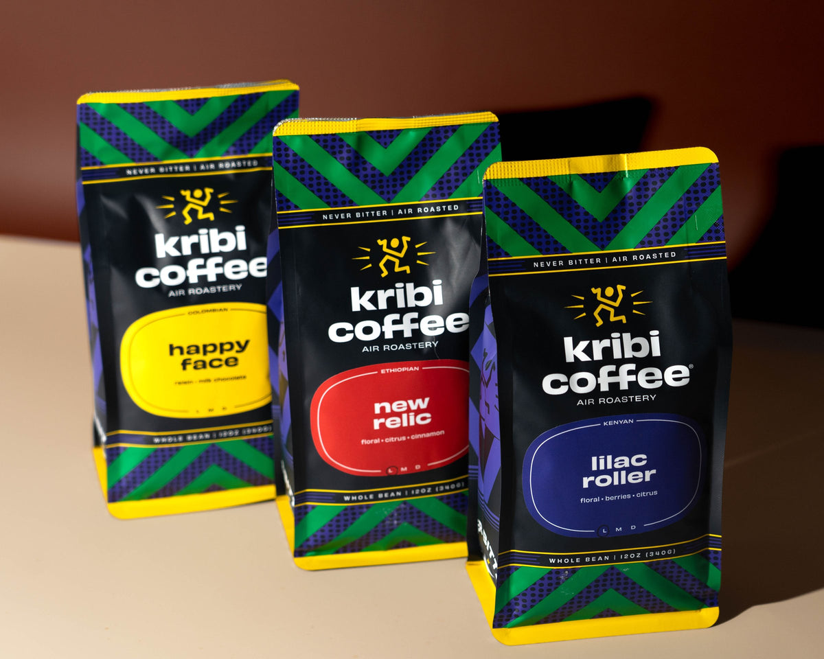 Three bags of Kribi Coffee in warm light