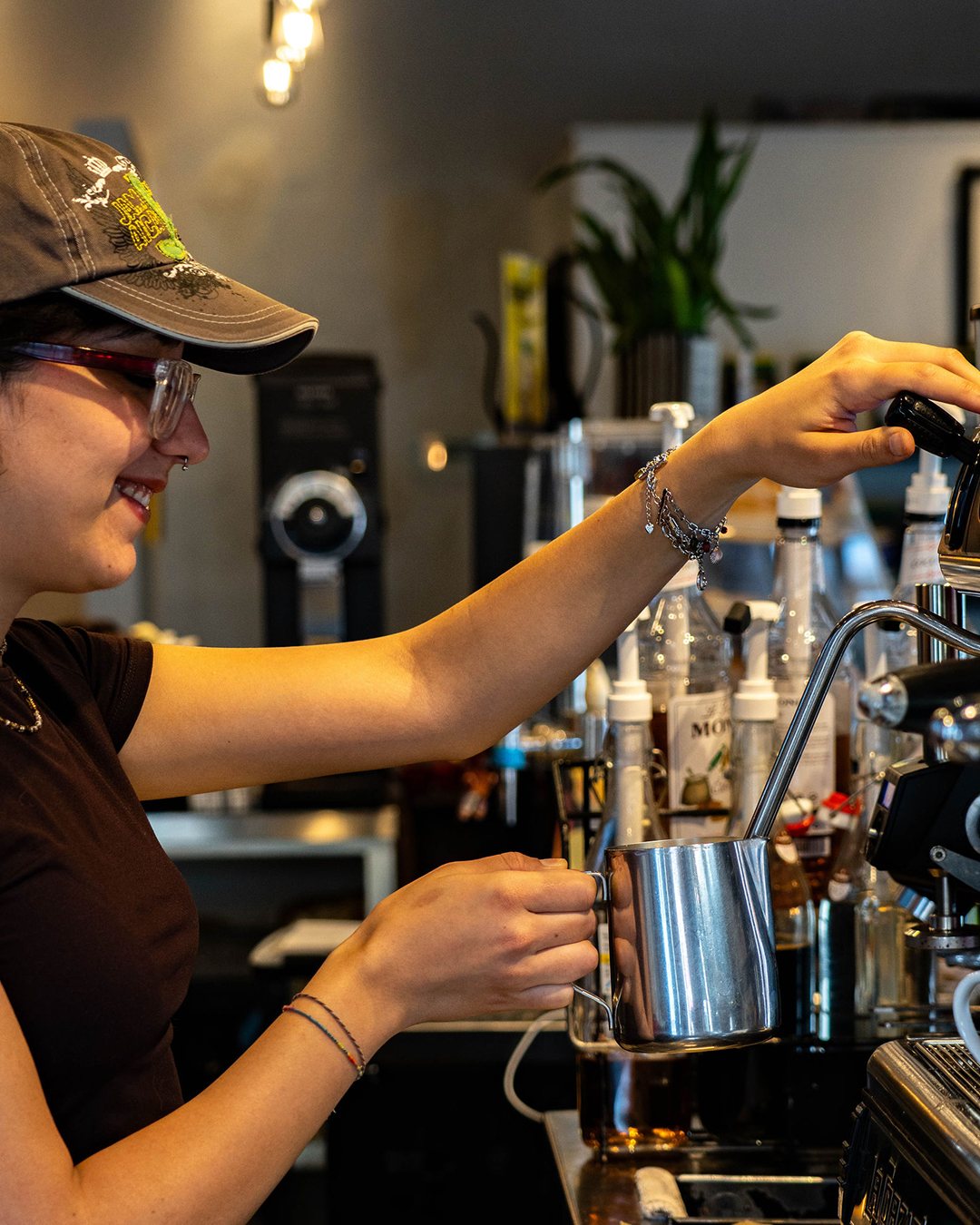 A barista steaming milk at our Forest Park cafe